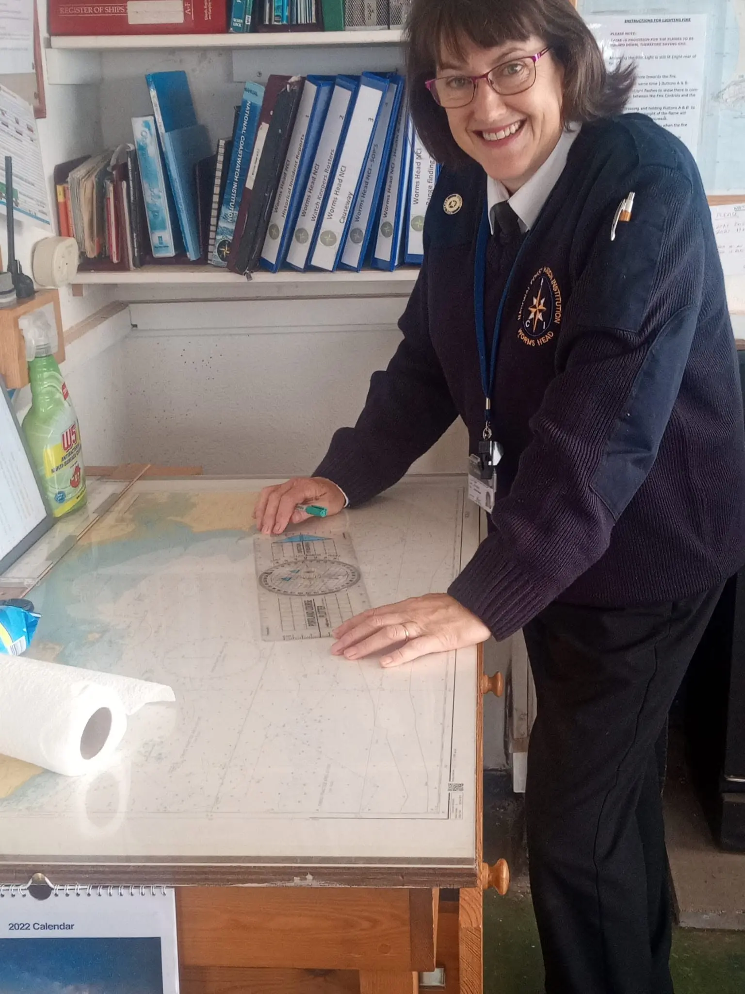 An NCI Worms Head watchkeeper plotting a position on a nautical chart