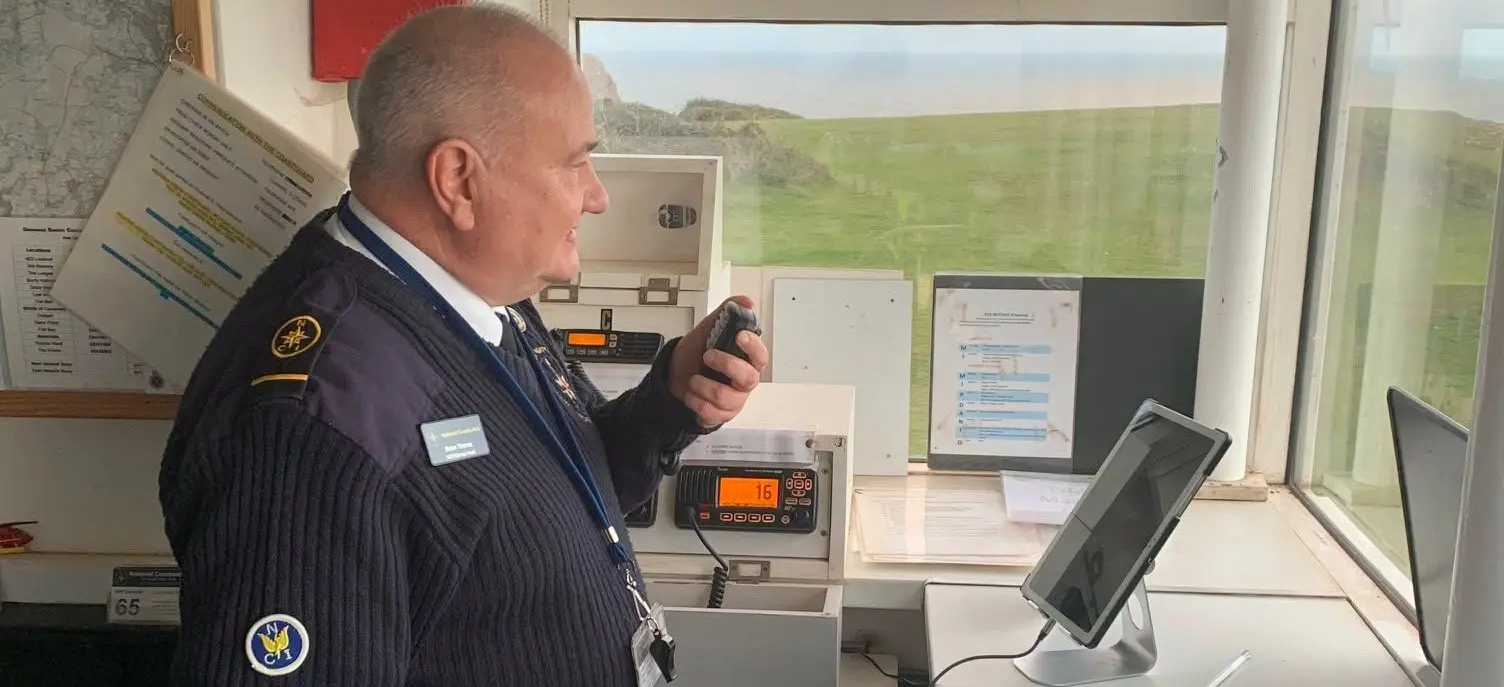 A watchkeeper using the VHF radio to communicate with nearby vessels