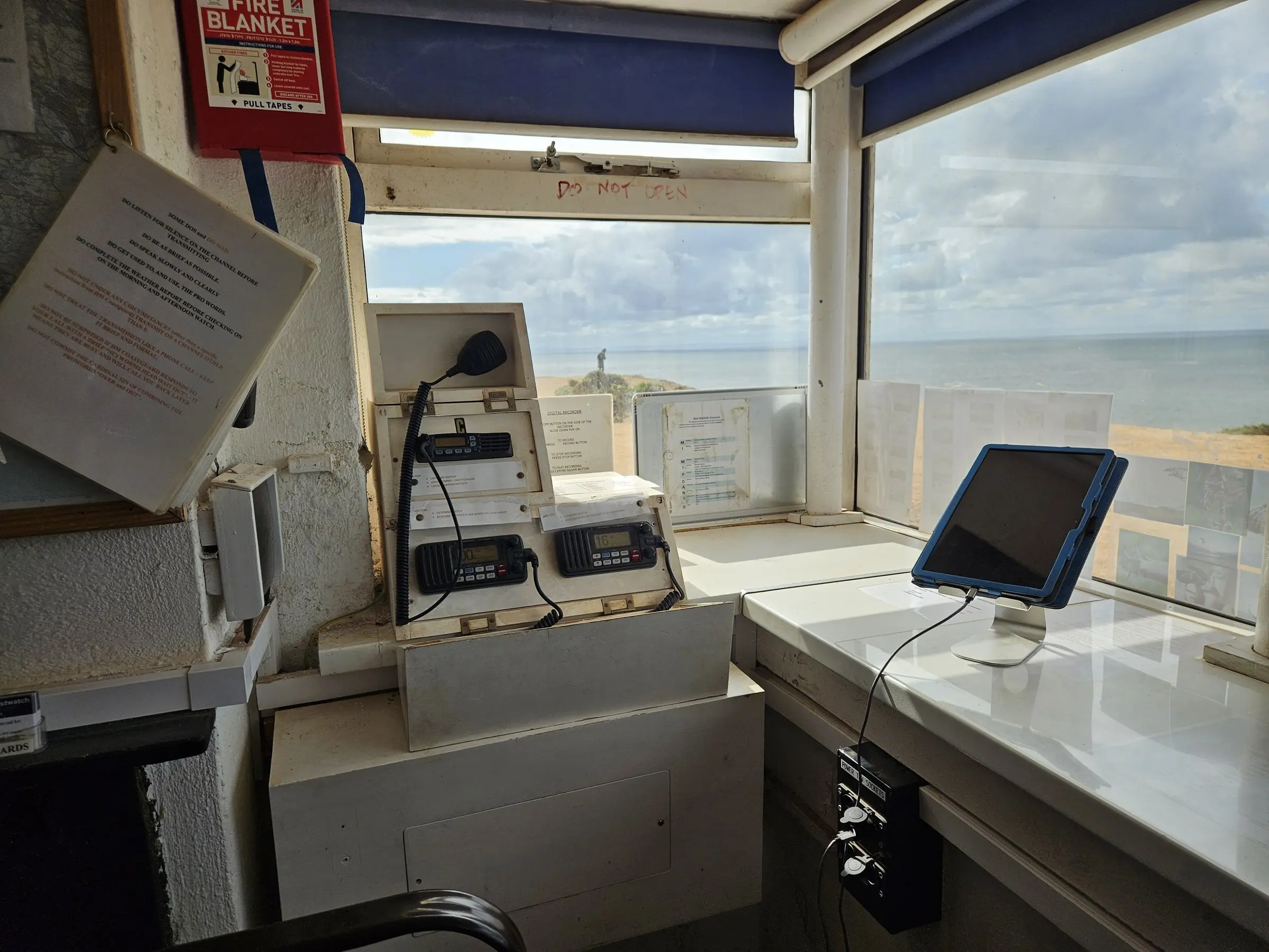 The radio desk in the NCI Worms Head watch room, with Worms Head visible through the window